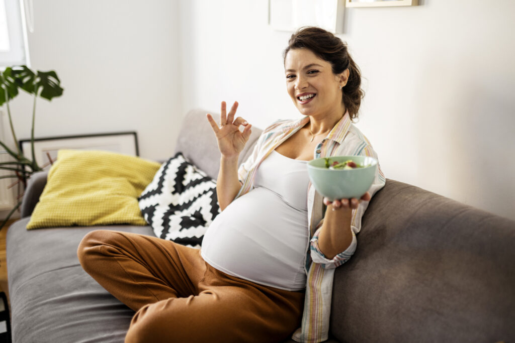 Young pregnant woman craving healthy food during pregnancy.