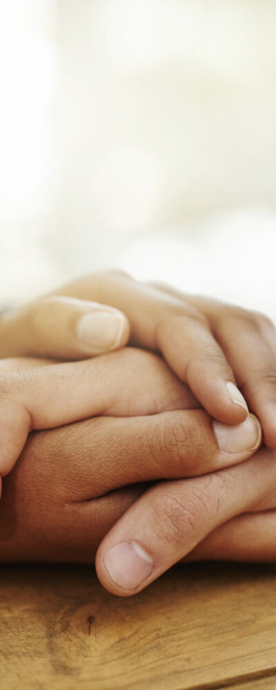 The staff and client holding hands while providing emotional support counseling.